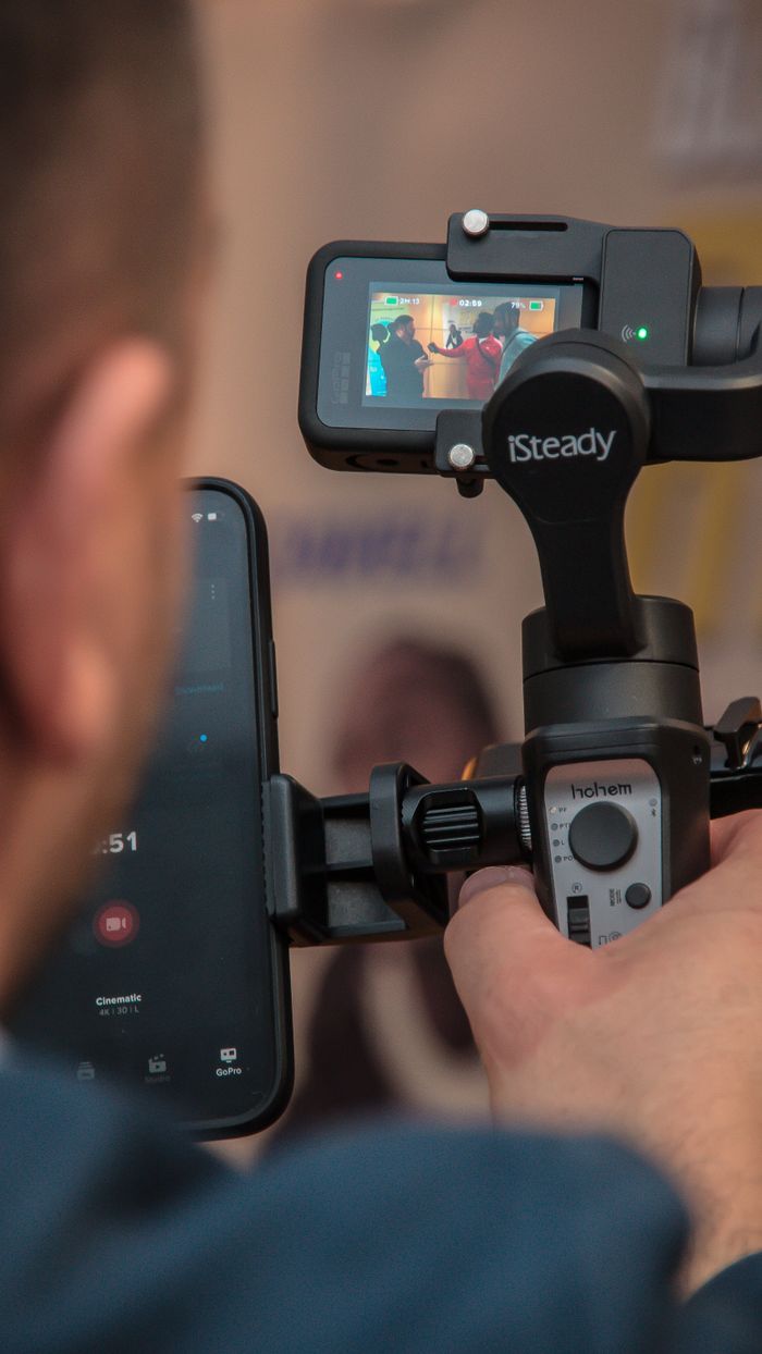 home-services-01 Man uses a smartphone stabilizer for filming, ensuring smooth footage with modern technology.